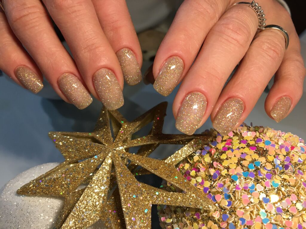 Sparkling gel nails with glitter embellishments and decorative detailing