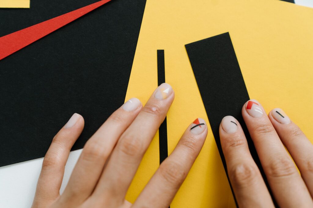 Creative nail art with geometric patterns and detailed artistic design work